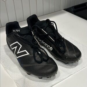 New Balance Black Burn X4 Lacrosse Cleats.